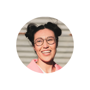 woman in a pink blazer with glasses